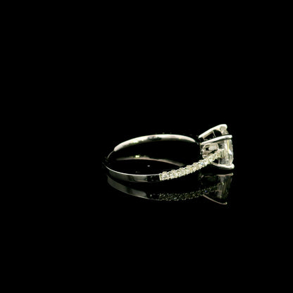 18K white gold engagement ring featuring a 1.50 carat IGI certified natural princess cut diamond with G color and SI2 clarity, accented by 0.20 carat natural round brilliant diamonds on the band.
