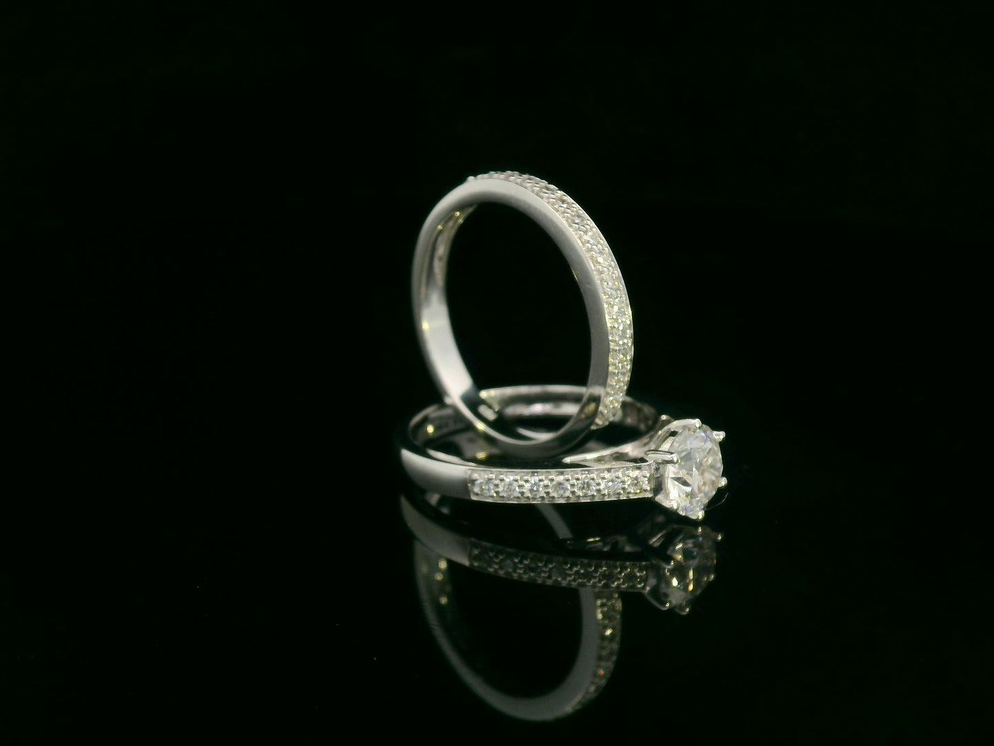 18K white gold diamond bridal ring set featuring a 1.01 carat GIA-certified round-cut center diamond with pavé diamond engagement ring and matching wedding band by Emirates Diamonds