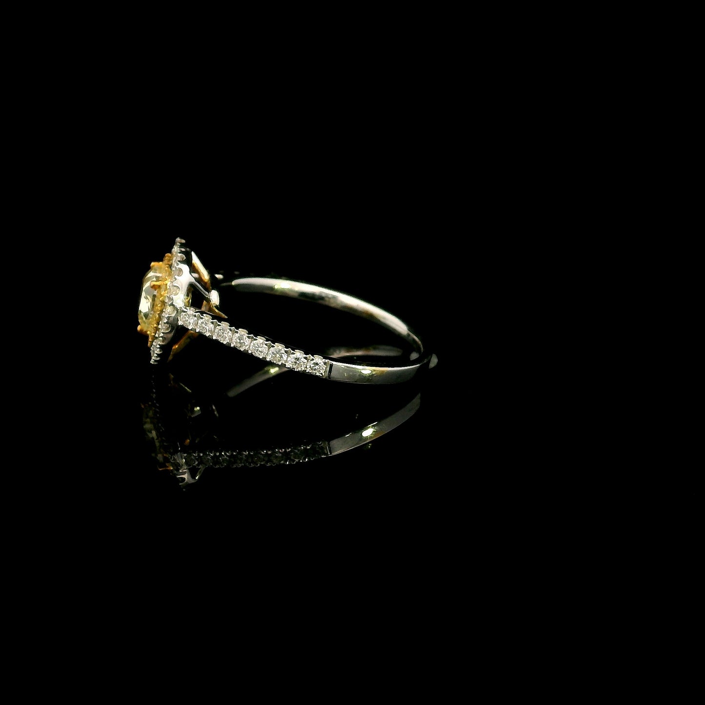 18K white gold engagement ring featuring a 0.73 carat GIA certified heart shaped Fancy Yellow diamond with VS2 clarity, surrounded by a yellow diamond halo, white diamond outer halo, and diamond set band.