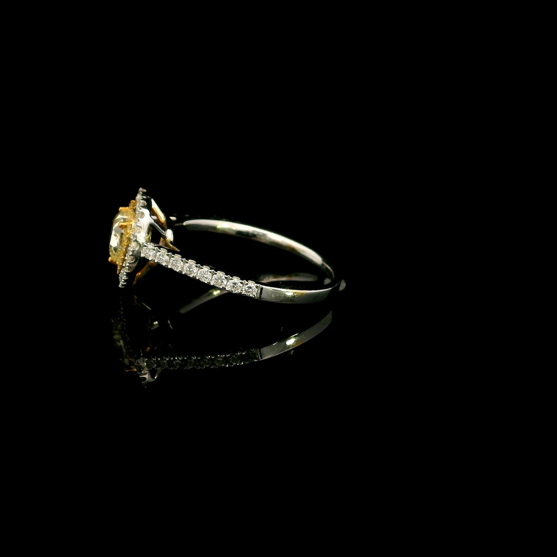 18K white gold engagement ring featuring a 0.73 carat GIA certified heart shaped Fancy Yellow diamond with VS2 clarity, surrounded by a yellow diamond halo, white diamond outer halo, and diamond set band.
