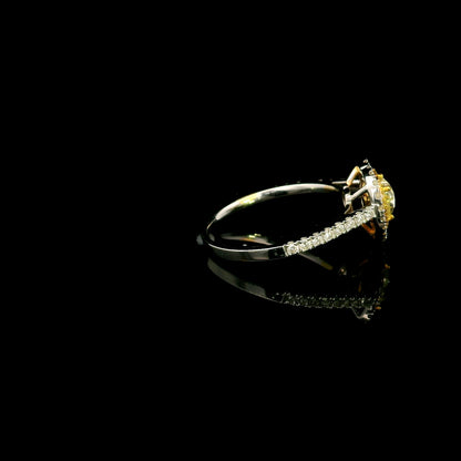18K white gold engagement ring featuring a 0.73 carat GIA certified heart shaped Fancy Yellow diamond with VS2 clarity, surrounded by a yellow diamond halo, white diamond outer halo, and diamond set band.