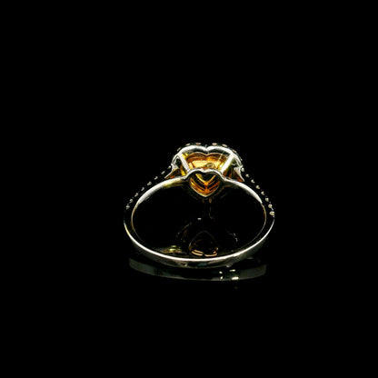 18K white gold engagement ring featuring a 0.73 carat GIA certified heart shaped Fancy Yellow diamond with VS2 clarity, surrounded by a yellow diamond halo, white diamond outer halo, and diamond set band.