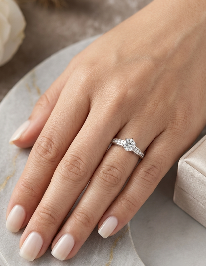 18K white gold engagement ring featuring a 0.60 carat GIA certified natural round brilliant diamond with F color and SI2 clarity, accented by 0.25 carat natural round diamonds on the shoulders in a classic six-prong setting.