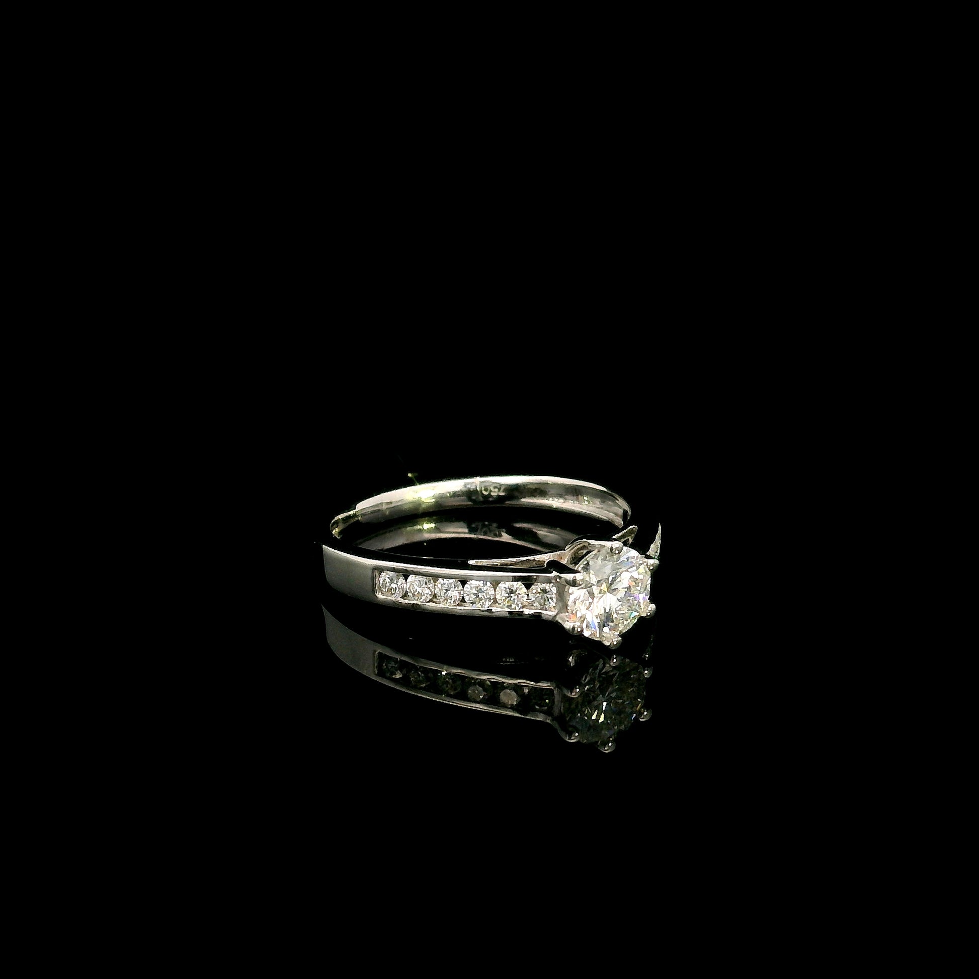 18K white gold engagement ring featuring a 0.60 carat GIA certified natural round brilliant diamond with F color and SI2 clarity, accented by 0.25 carat natural round diamonds on the shoulders in a classic six-prong setting.