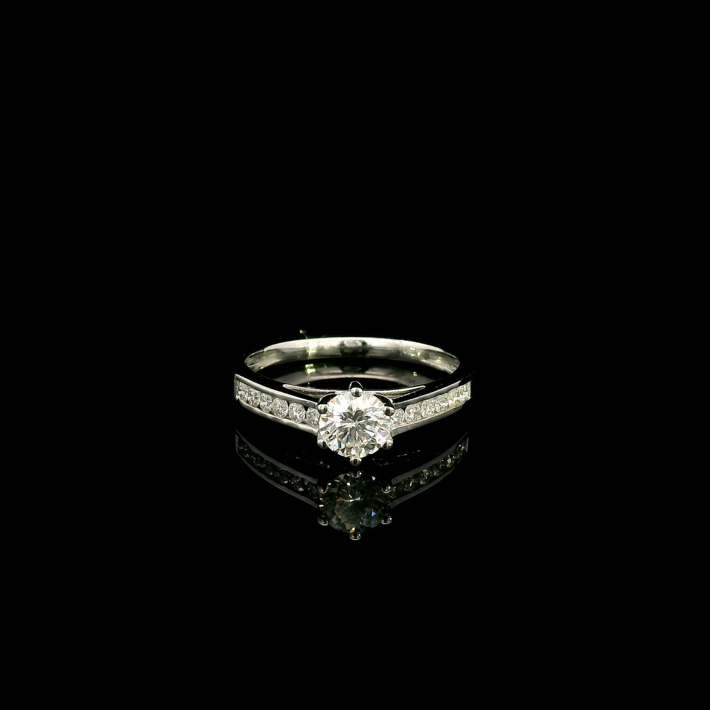 18K white gold engagement ring featuring a 0.60 carat GIA certified natural round brilliant diamond with F color and SI2 clarity, accented by 0.25 carat natural round diamonds on the shoulders in a classic six-prong setting.
