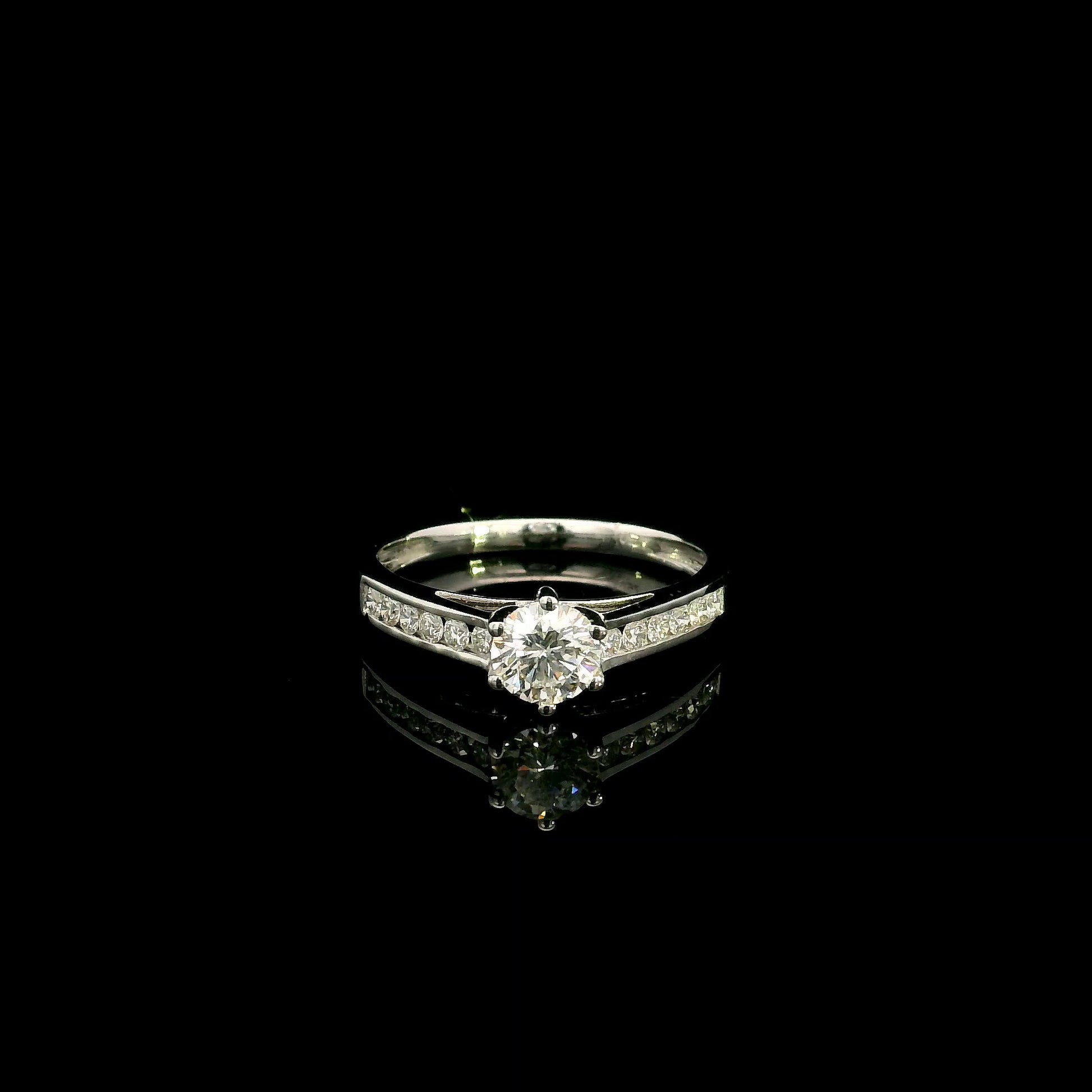 18K white gold engagement ring featuring a 0.60 carat GIA certified natural round brilliant diamond with F color and SI2 clarity, accented by 0.25 carat natural round diamonds on the shoulders in a classic six-prong setting.