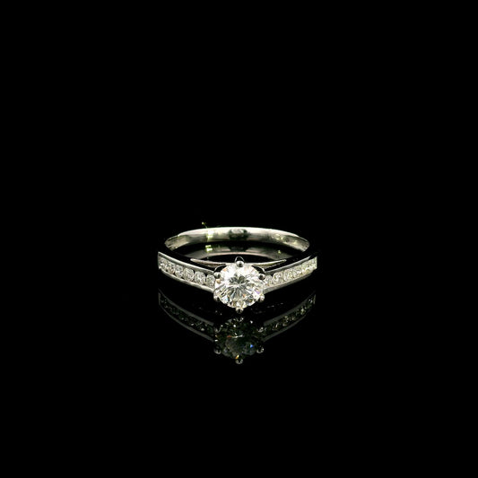 18K white gold engagement ring featuring a 0.60 carat GIA certified natural round brilliant diamond with F color and SI2 clarity, accented by 0.25 carat natural round diamonds on the shoulders in a classic six-prong setting.