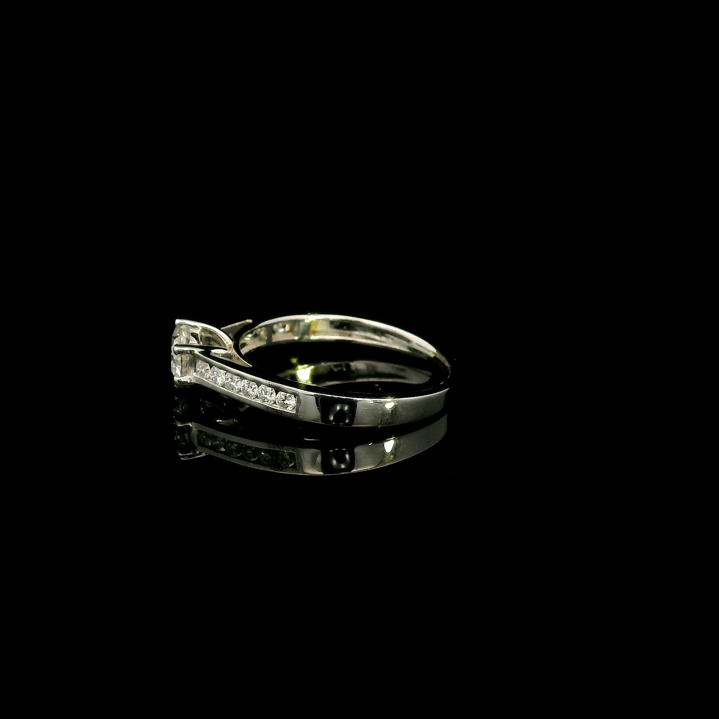 18K white gold engagement ring featuring a 0.60 carat GIA certified natural round brilliant diamond with F color and SI2 clarity, accented by 0.25 carat natural round diamonds on the shoulders in a classic six-prong setting.