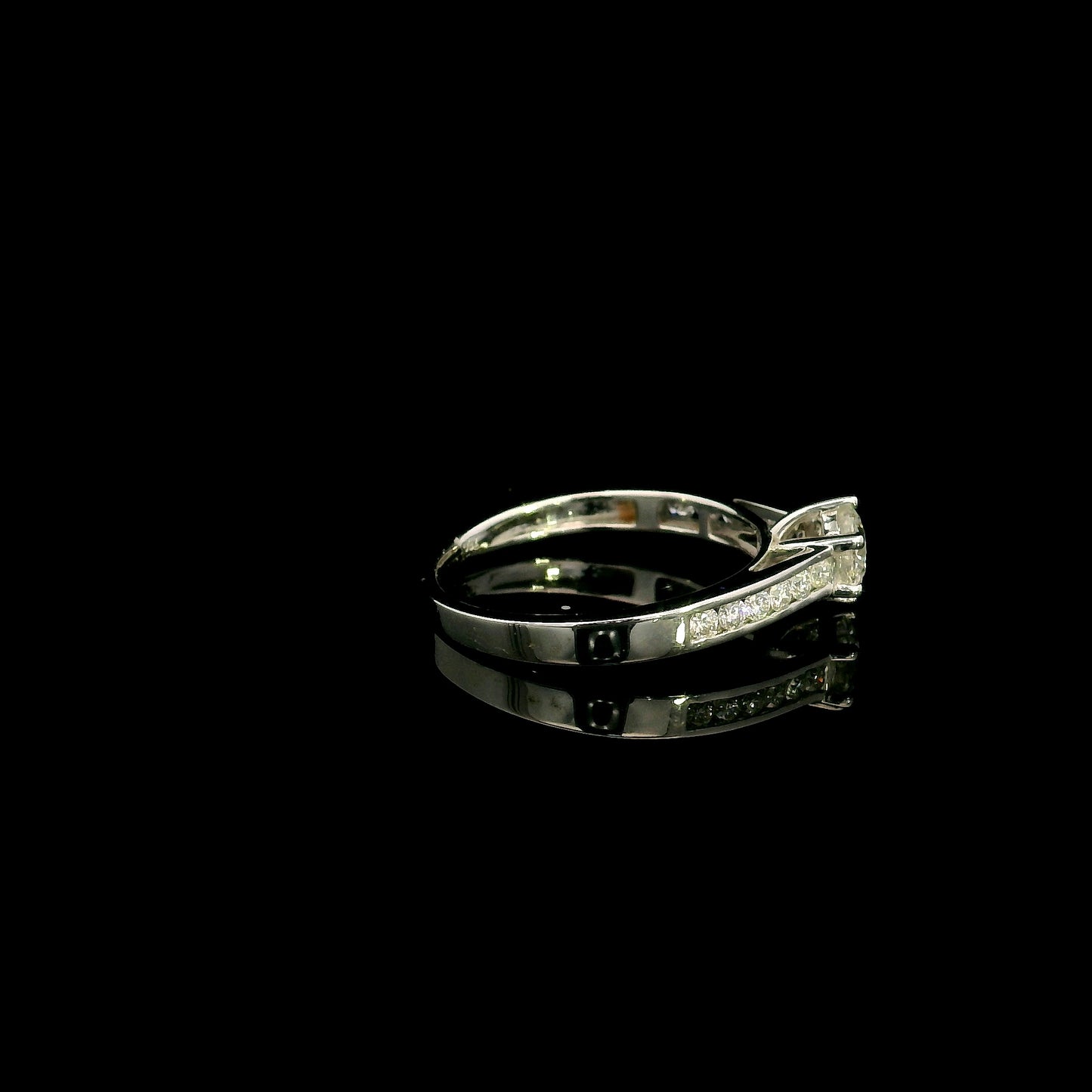 18K white gold engagement ring featuring a 0.60 carat GIA certified natural round brilliant diamond with F color and SI2 clarity, accented by 0.25 carat natural round diamonds on the shoulders in a classic six-prong setting.