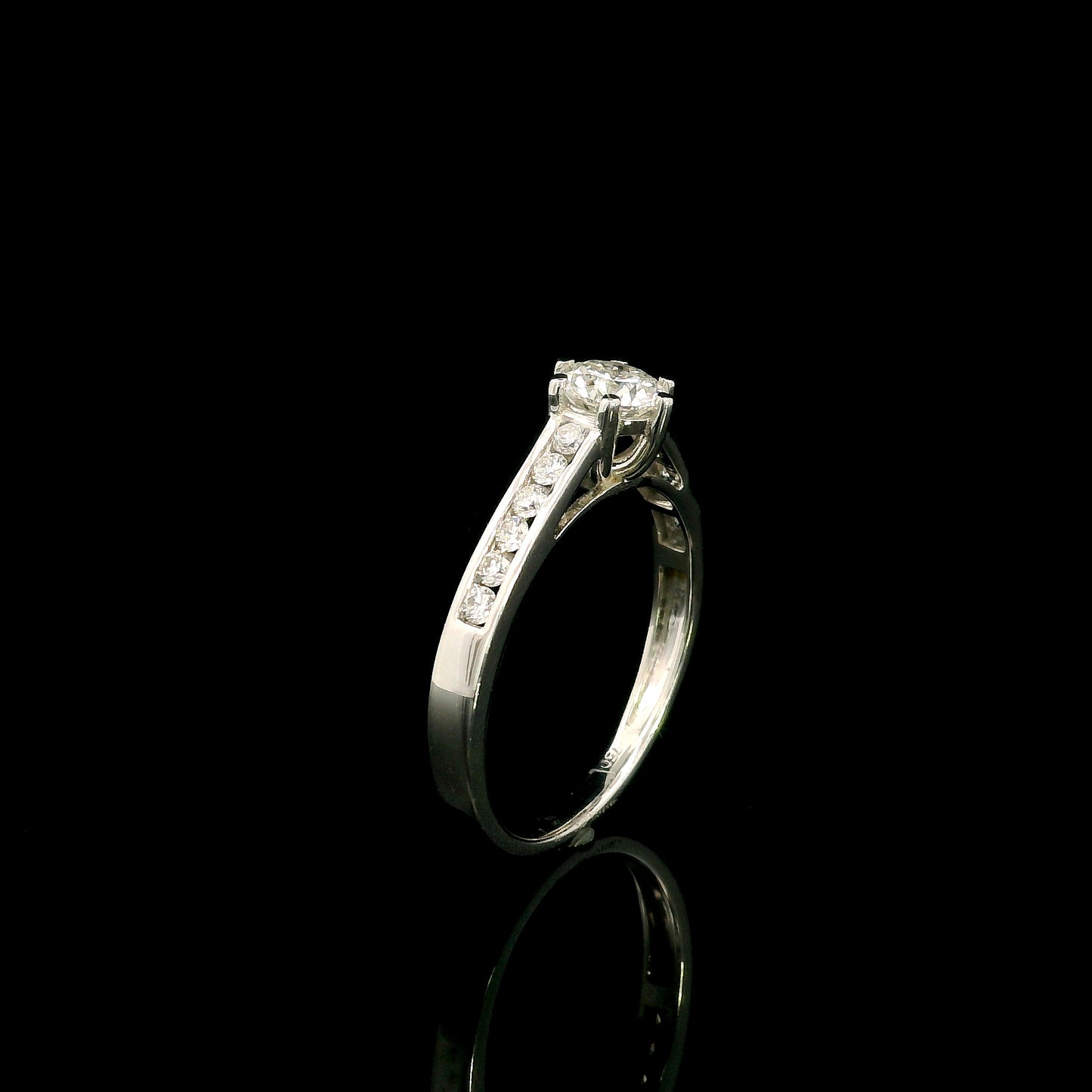 18K white gold engagement ring featuring a 0.60 carat GIA certified natural round brilliant diamond with F color and SI2 clarity, accented by 0.25 carat natural round diamonds on the shoulders in a classic six-prong setting.