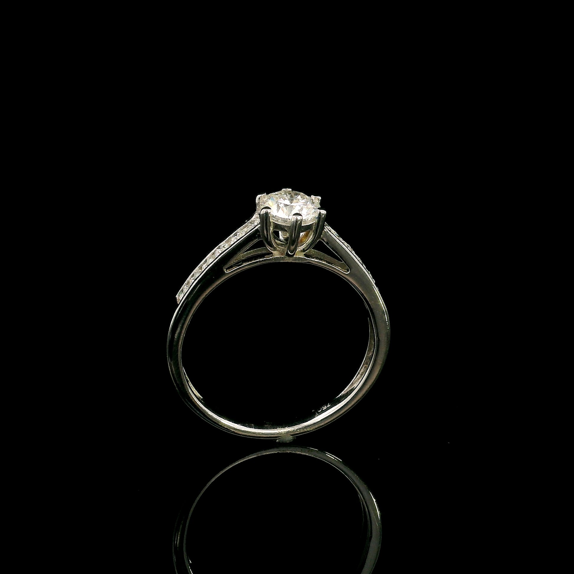 18K white gold engagement ring featuring a 0.60 carat GIA certified natural round brilliant diamond with F color and SI2 clarity, accented by 0.25 carat natural round diamonds on the shoulders in a classic six-prong setting.