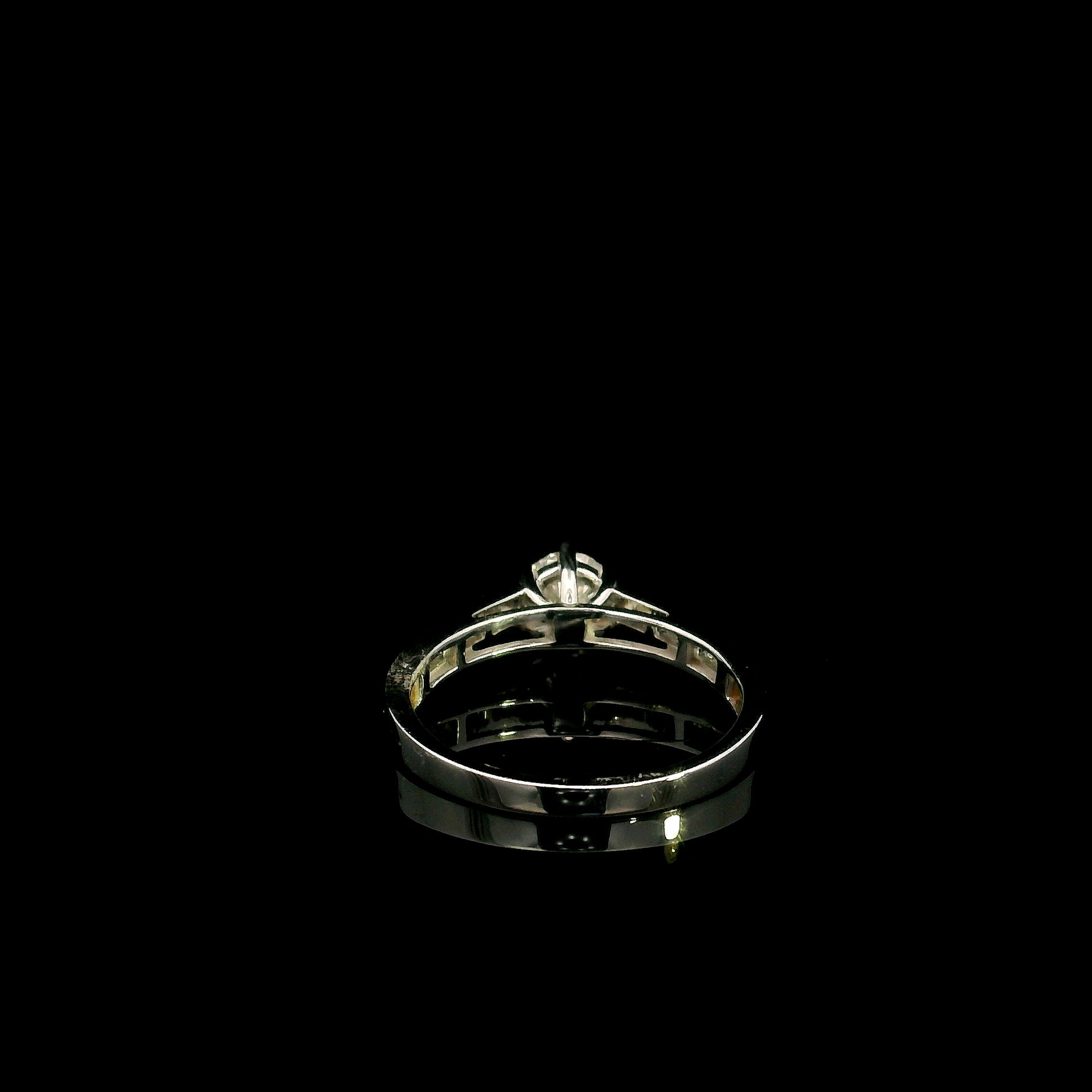18K white gold engagement ring featuring a 0.60 carat GIA certified natural round brilliant diamond with F color and SI2 clarity, accented by 0.25 carat natural round diamonds on the shoulders in a classic six-prong setting.