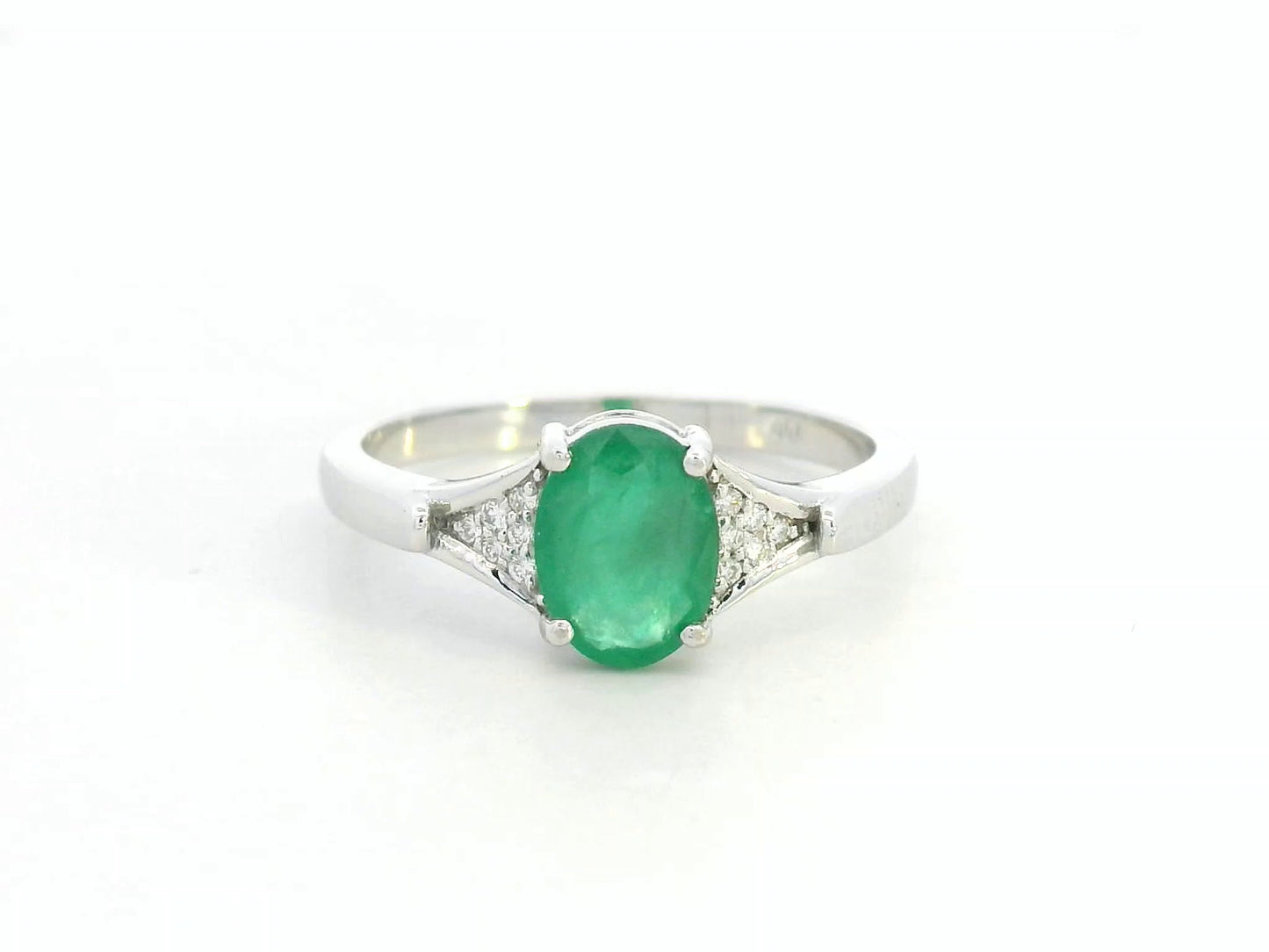 Oval emerald ring in 18K white gold with subtle diamond accents by Emirates Diamonds