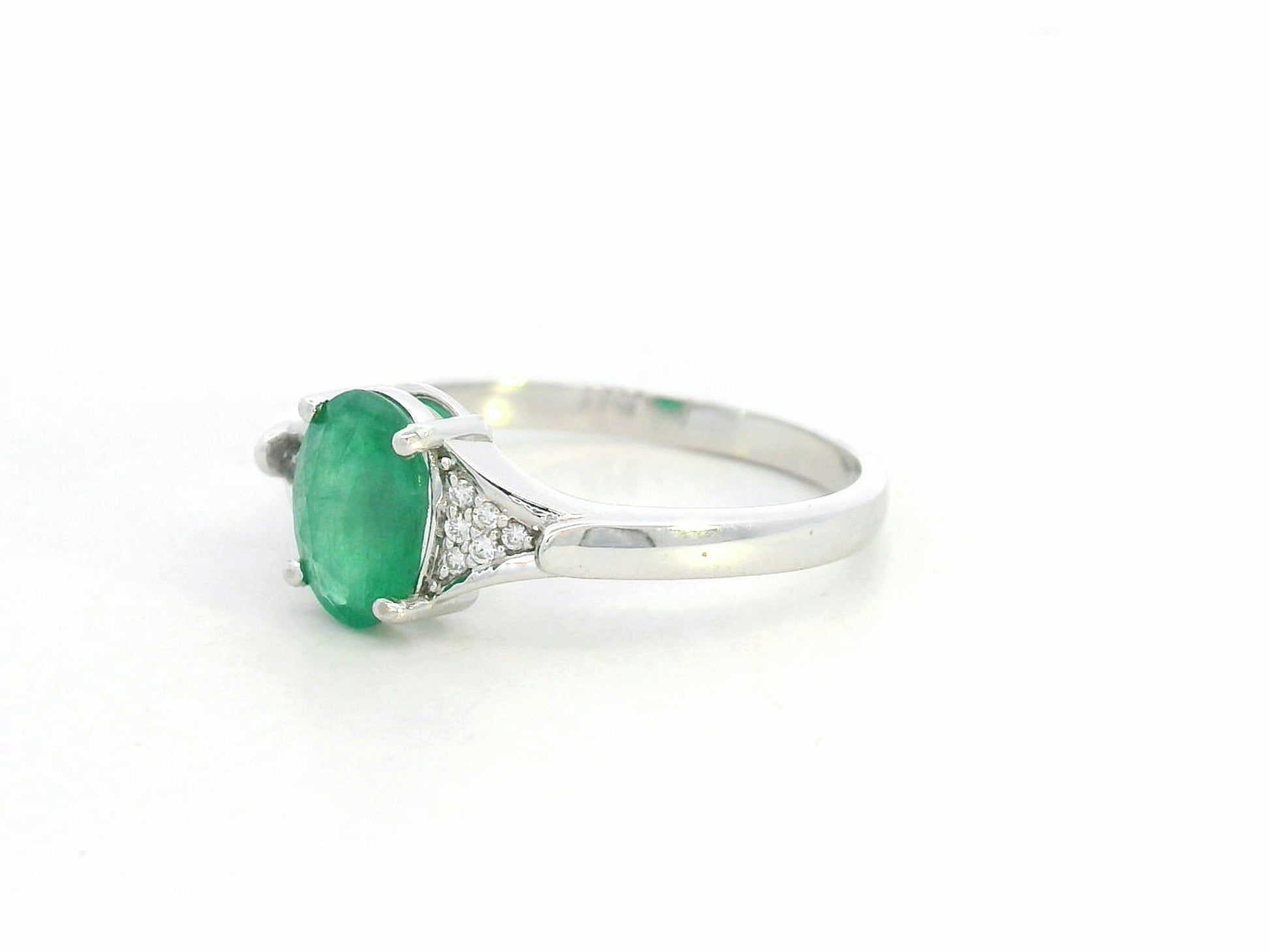 Oval emerald ring in 18K white gold with subtle diamond accents by Emirates Diamonds