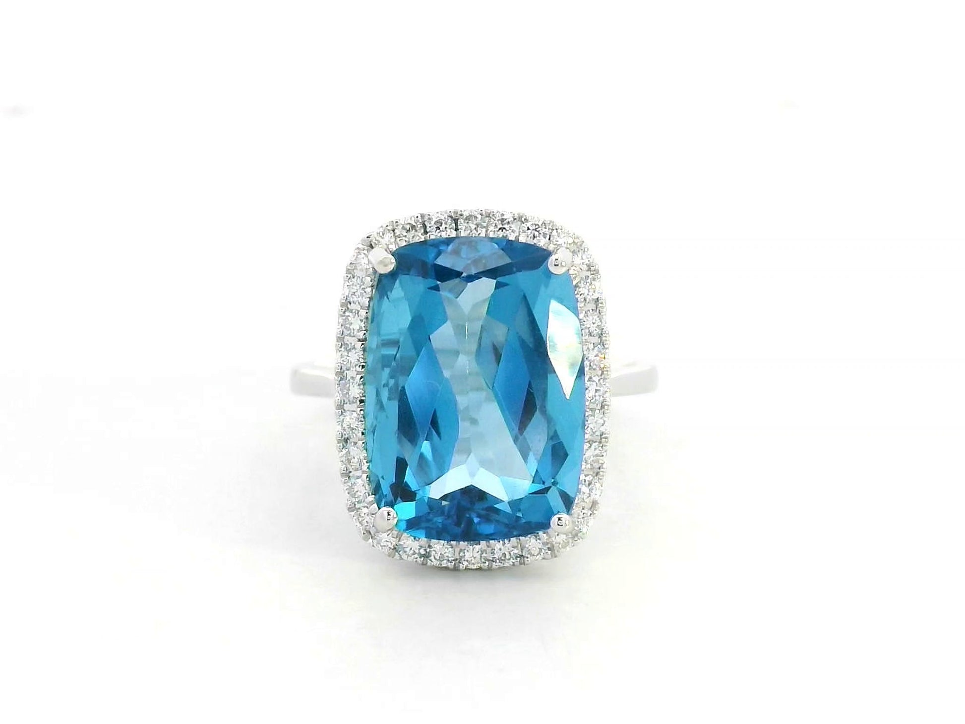 Elongated cushion-cut blue topaz halo ring in 18K white gold with natural diamonds by Emirates Diamonds