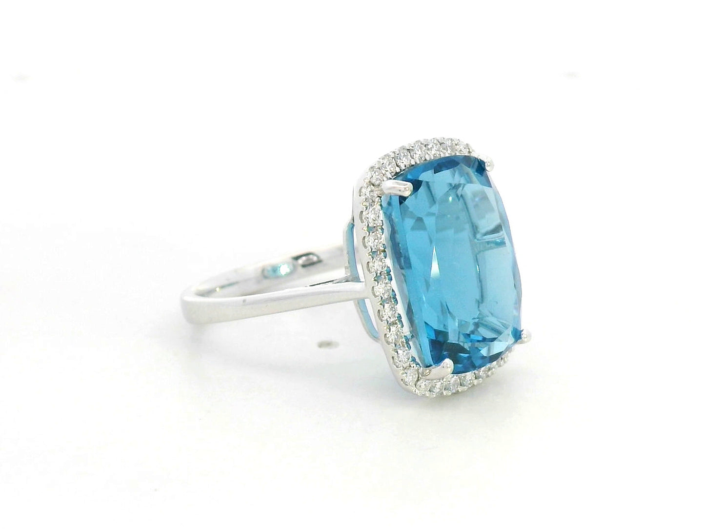 Elongated cushion-cut blue topaz halo ring in 18K white gold with natural diamonds by Emirates Diamonds