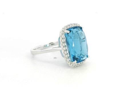 Elongated cushion-cut blue topaz halo ring in 18K white gold with natural diamonds by Emirates Diamonds