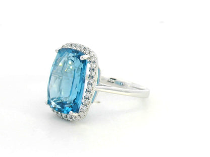 Elongated cushion-cut blue topaz halo ring in 18K white gold with natural diamonds by Emirates Diamonds