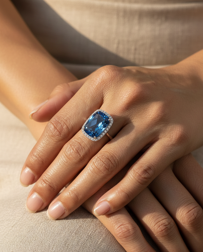 Elongated cushion-cut blue topaz halo ring in 18K white gold with natural diamonds by Emirates Diamonds