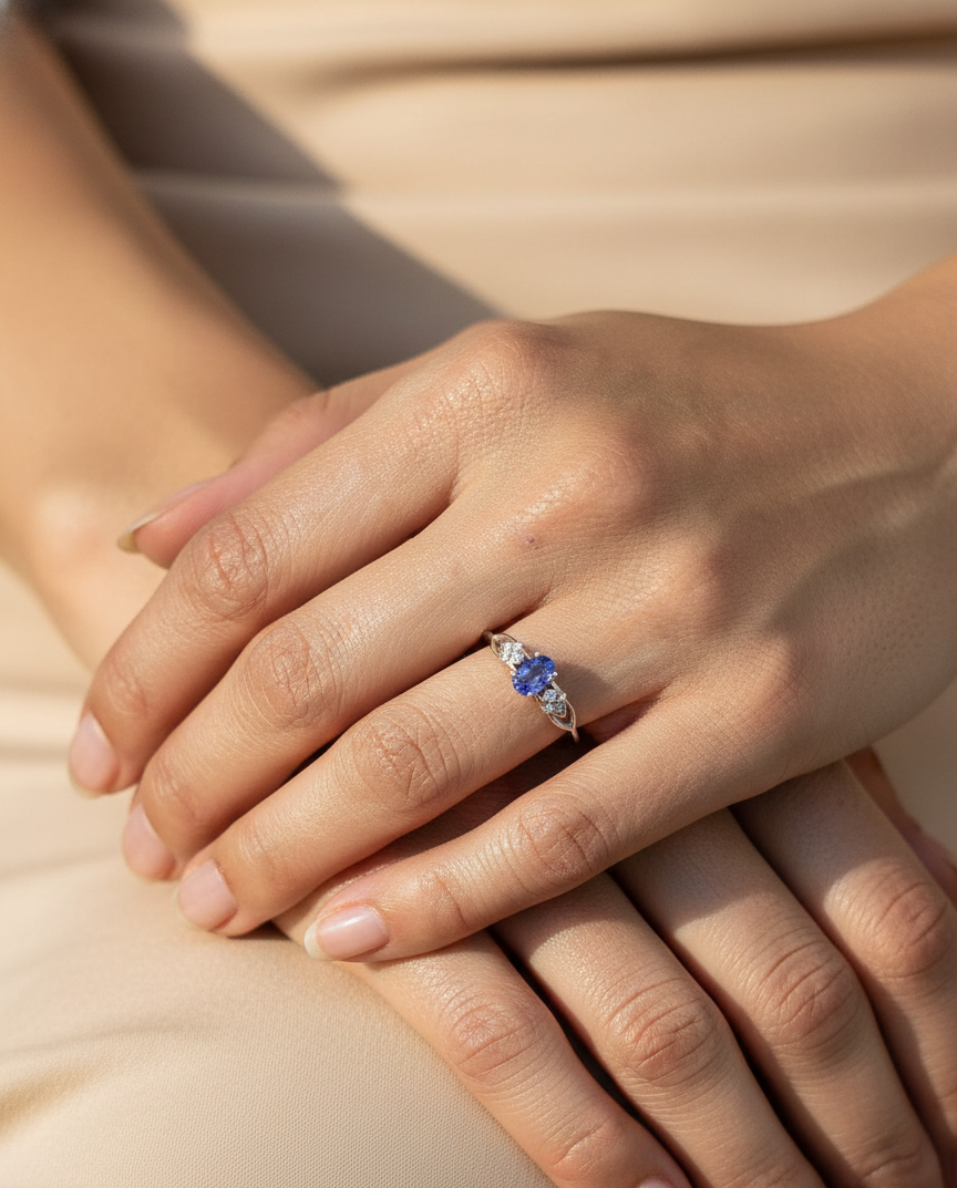 Oval tanzanite and diamond ring in 18K white gold with delicate side diamonds by Emirates Diamonds