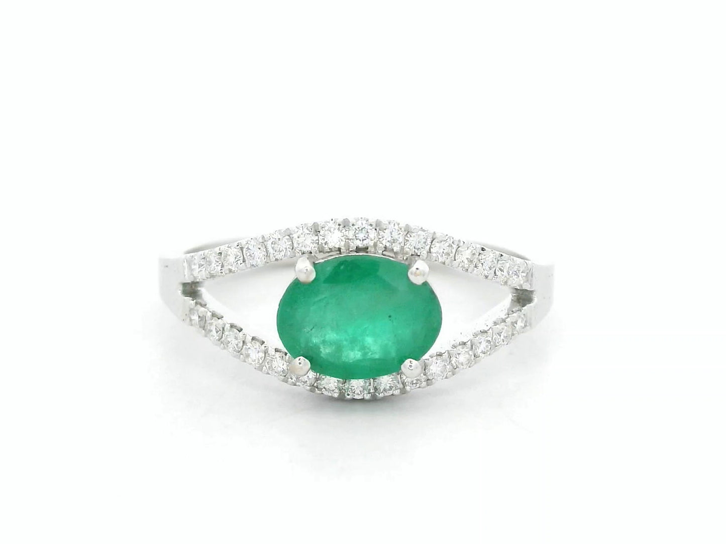 18K white gold emerald bypass ring with 0.98 carat emerald and 0.26 carat diamond accents by Emirates Diamonds
