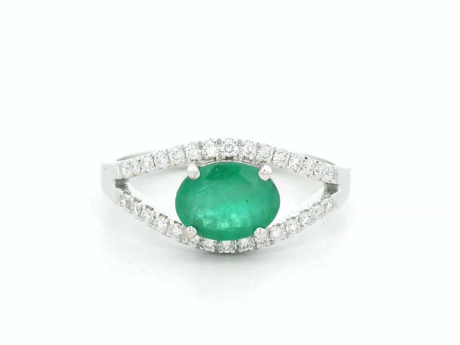 18K white gold emerald bypass ring with 0.98 carat emerald and 0.26 carat diamond accents by Emirates Diamonds