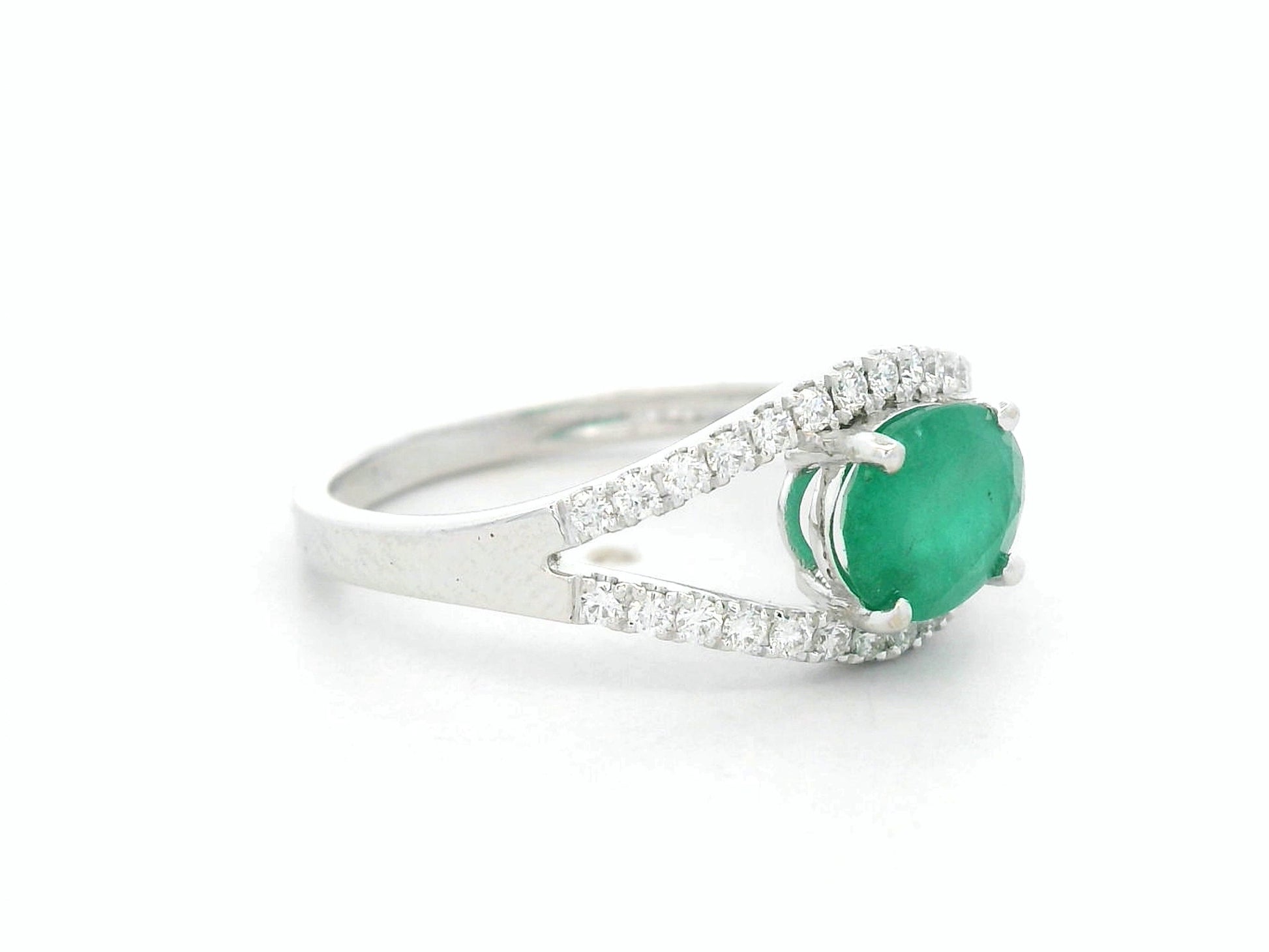 18K white gold emerald bypass ring with 0.98 carat emerald and 0.26 carat diamond accents by Emirates Diamonds