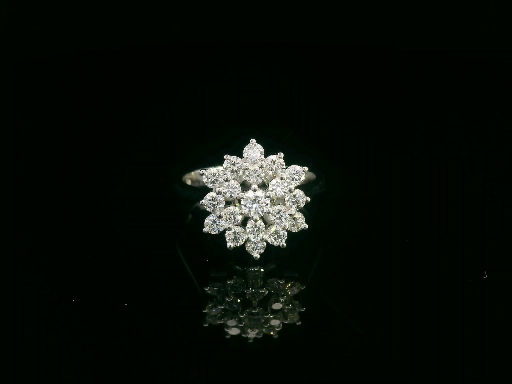 18K white gold diamond cluster ring with round brilliant diamonds in a floral-inspired setting by Emirates Diamonds