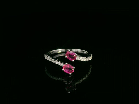 18K white gold open bypass ring with oval ruby gemstones and pavé diamond accents – fine ruby and diamond jewelry by Emirates Diamonds.