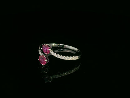 18K white gold open bypass ring with oval ruby gemstones and pavé diamond accents – fine ruby and diamond jewelry by Emirates Diamonds.