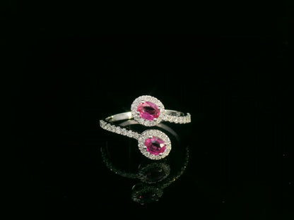 18K white gold ruby and diamond bypass ring with dual oval rubies and diamond halos by Emirates Diamonds