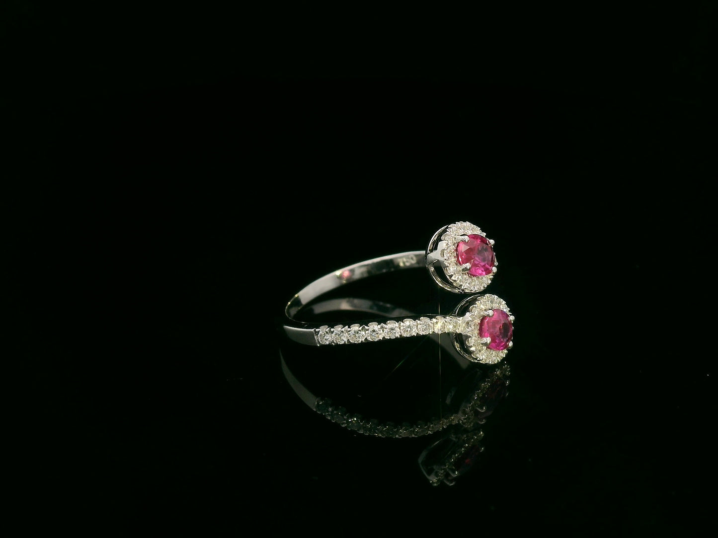 18K white gold ruby and diamond bypass ring with dual oval rubies and diamond halos by Emirates Diamonds