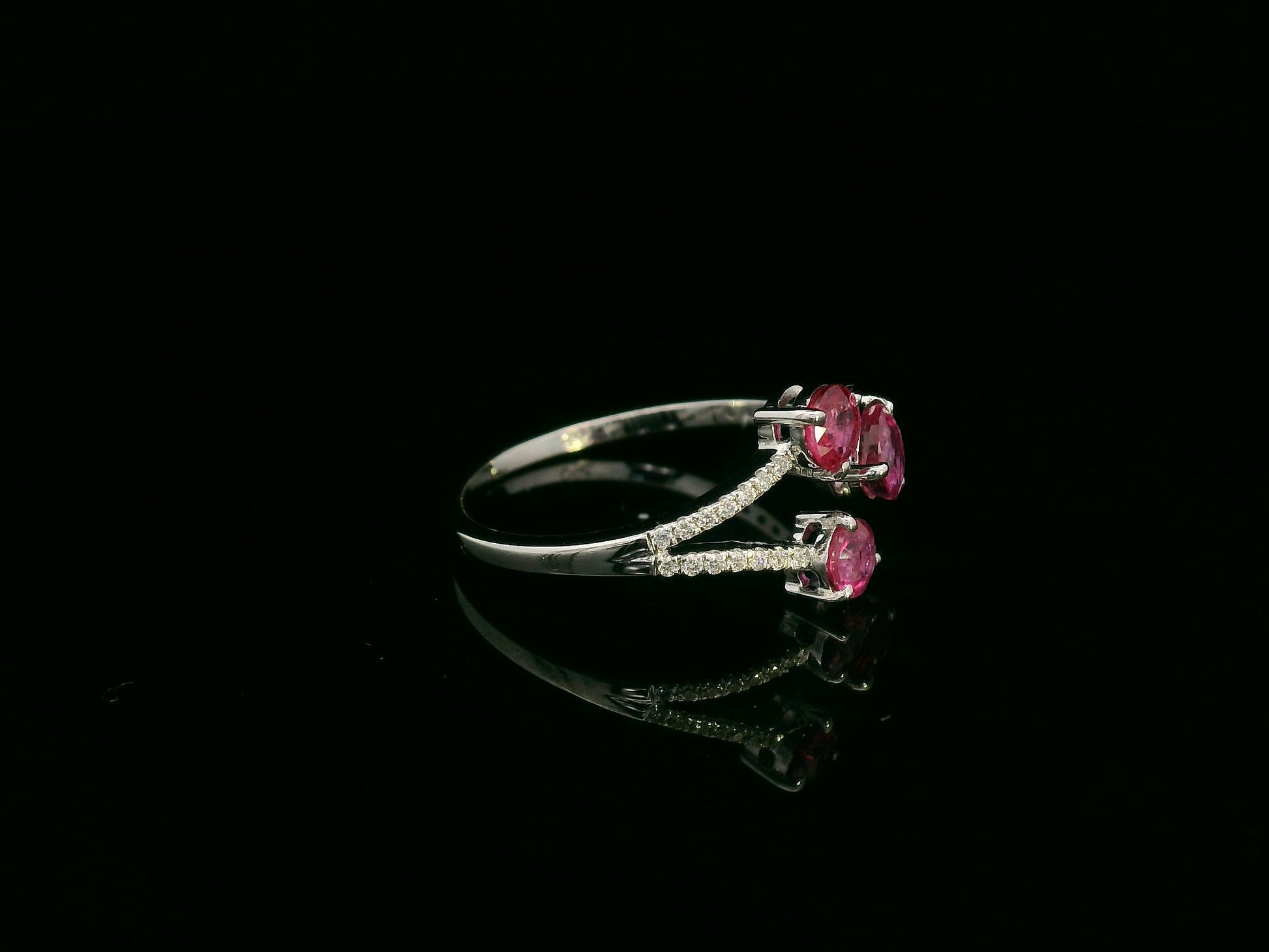 18K white gold open wrap ring with rubies and diamond accents by Emirates Diamonds