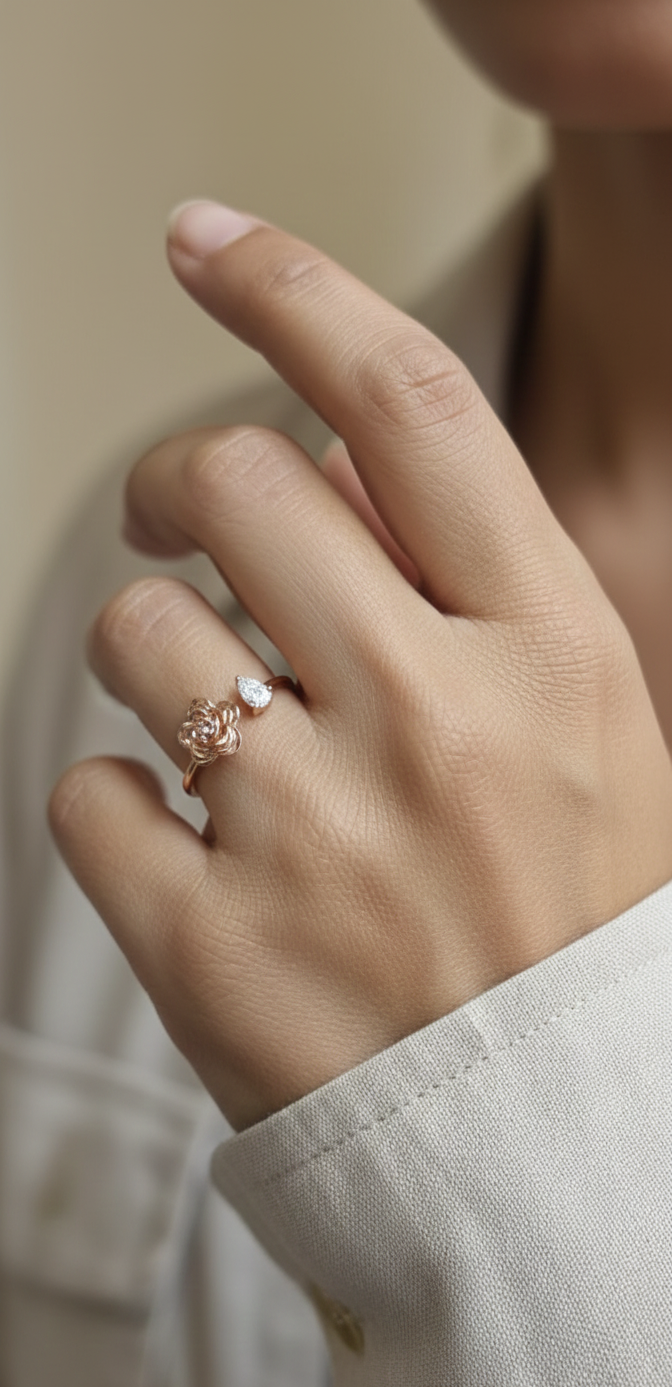 18K rose gold bypass ring featuring a 0.18 carat pear-cut diamond with sculpted floral gold detail – Emirates Diamonds