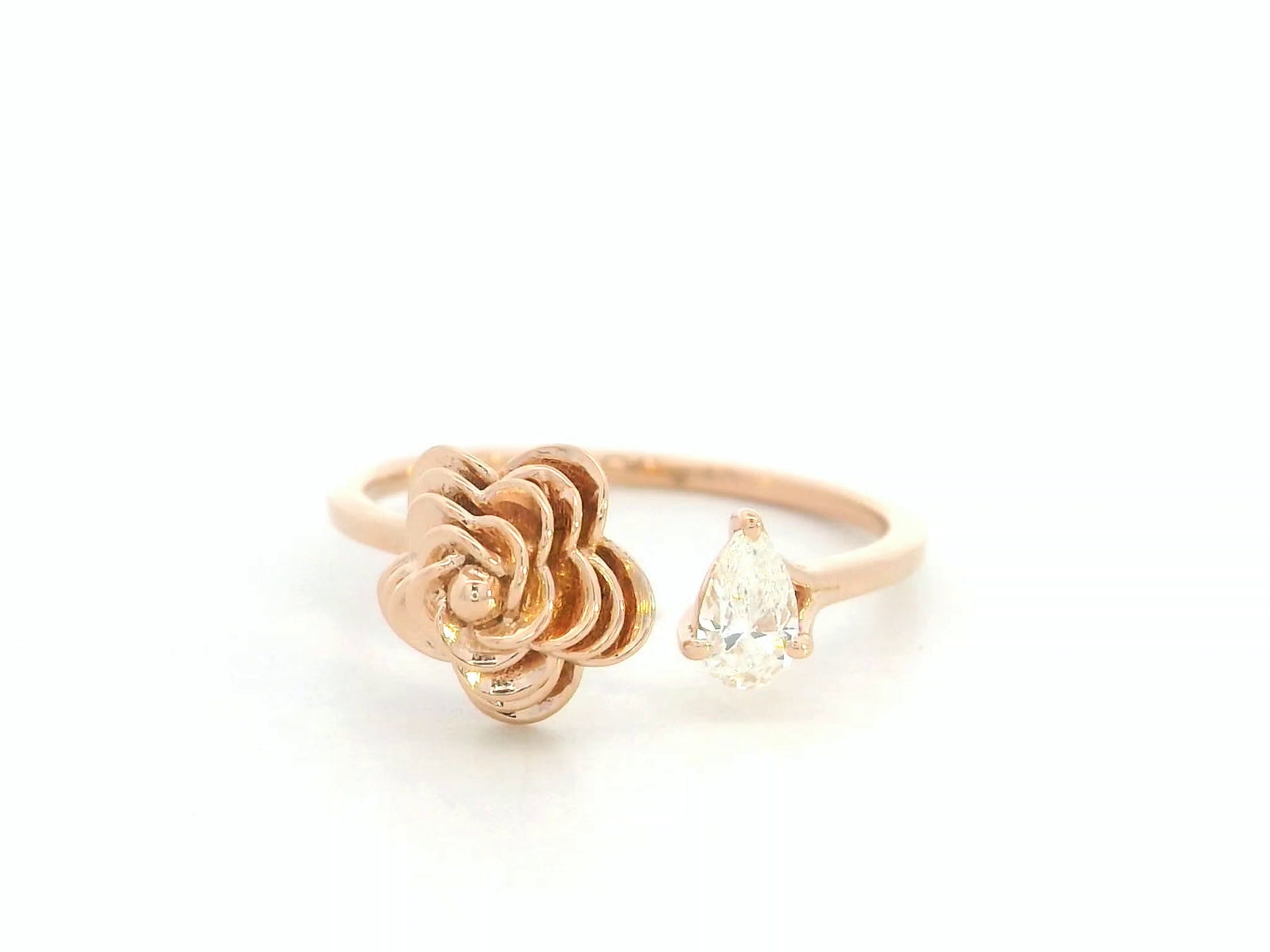 18K rose gold bypass ring featuring a 0.18 carat pear-cut diamond with sculpted floral gold detail – Emirates Diamonds