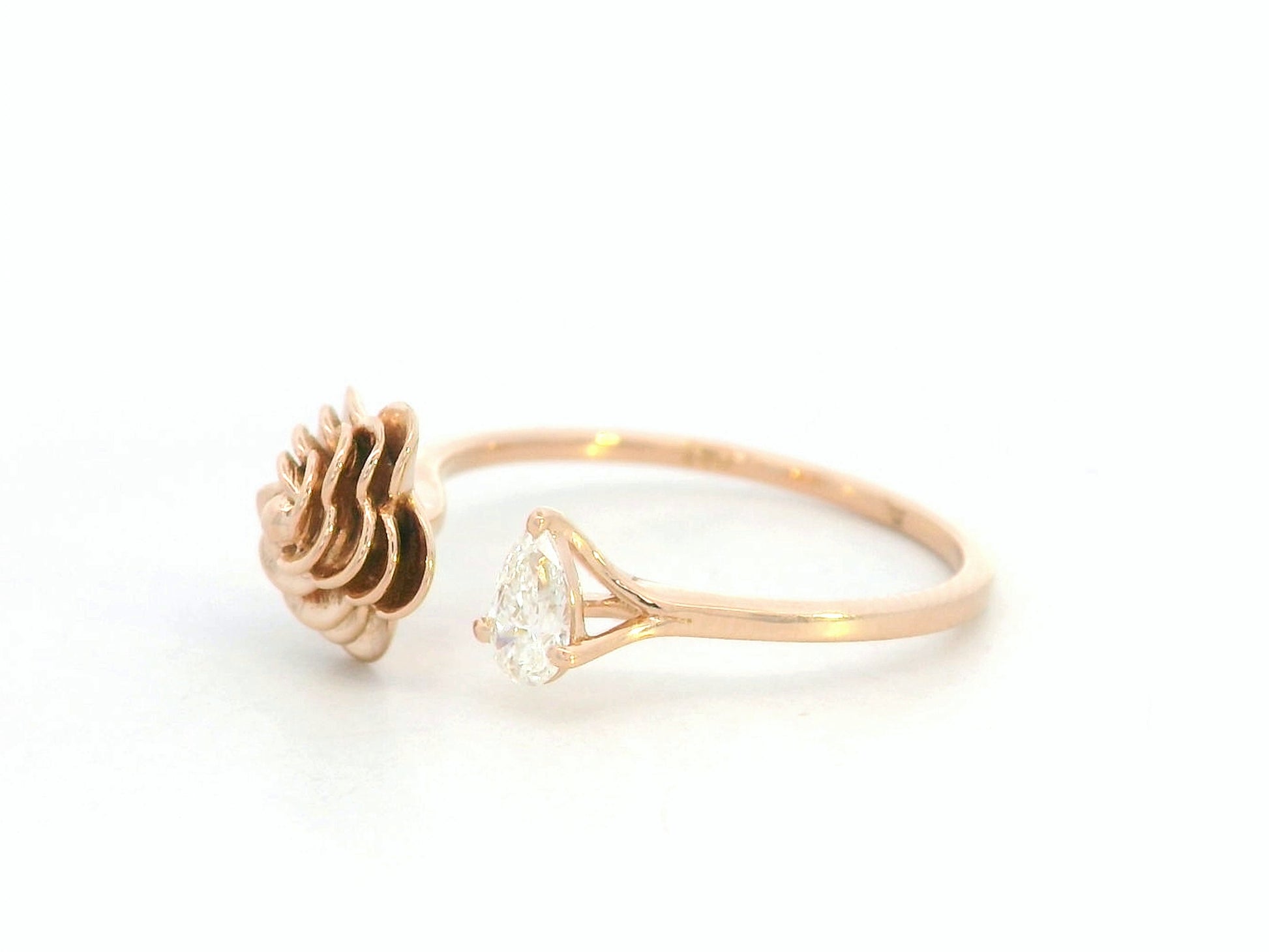 18K rose gold bypass ring featuring a 0.18 carat pear-cut diamond with sculpted floral gold detail – Emirates Diamonds