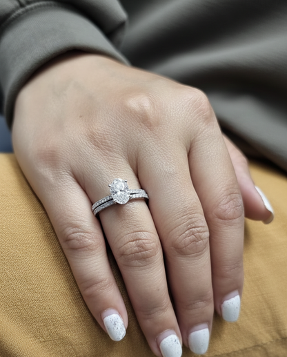 18K white gold oval diamond bridal ring set with IGI certified diamond and matching wedding band by Emirates Diamonds.
