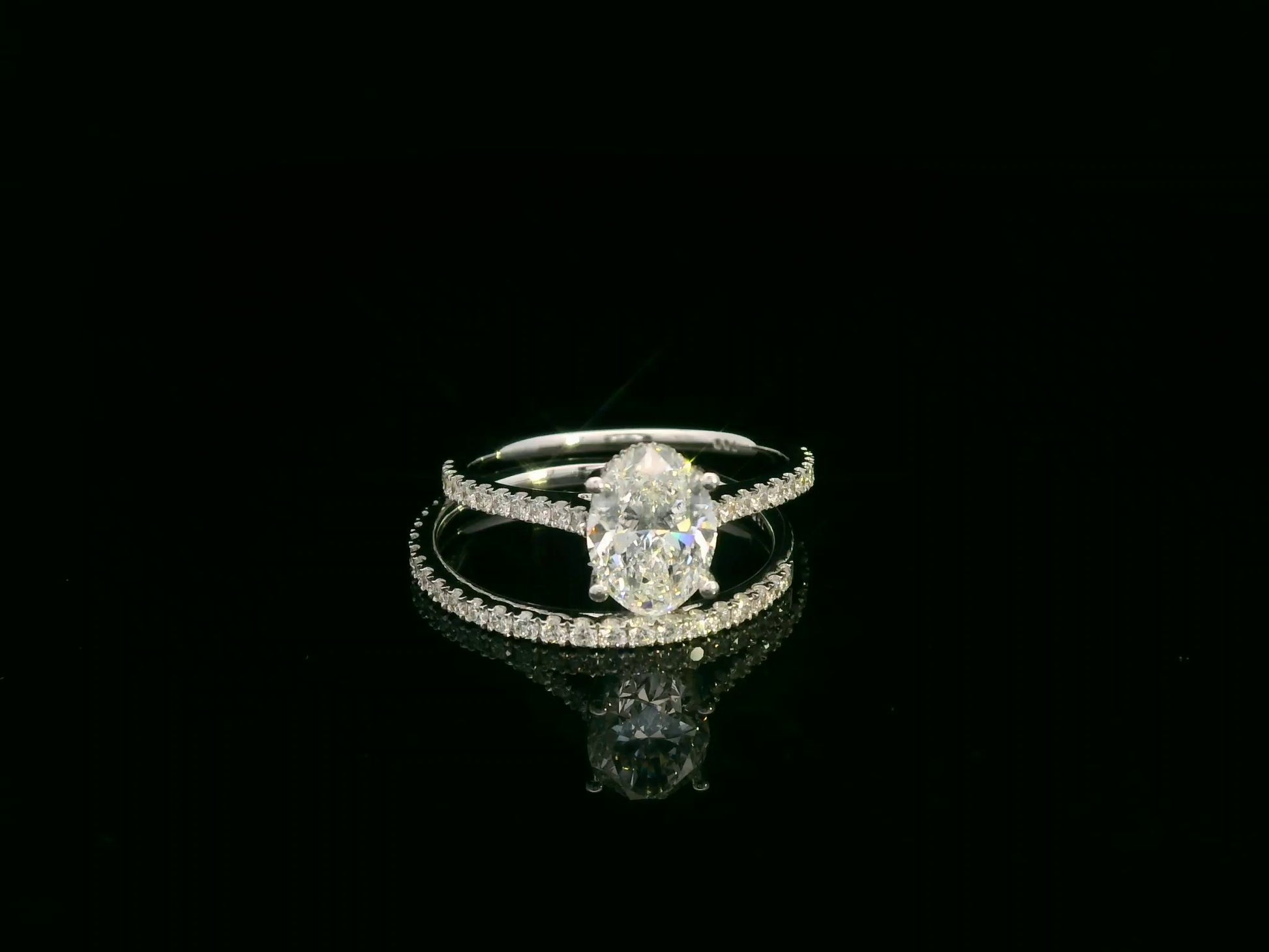 18K white gold oval diamond bridal ring set with IGI certified diamond and matching wedding band by Emirates Diamonds.