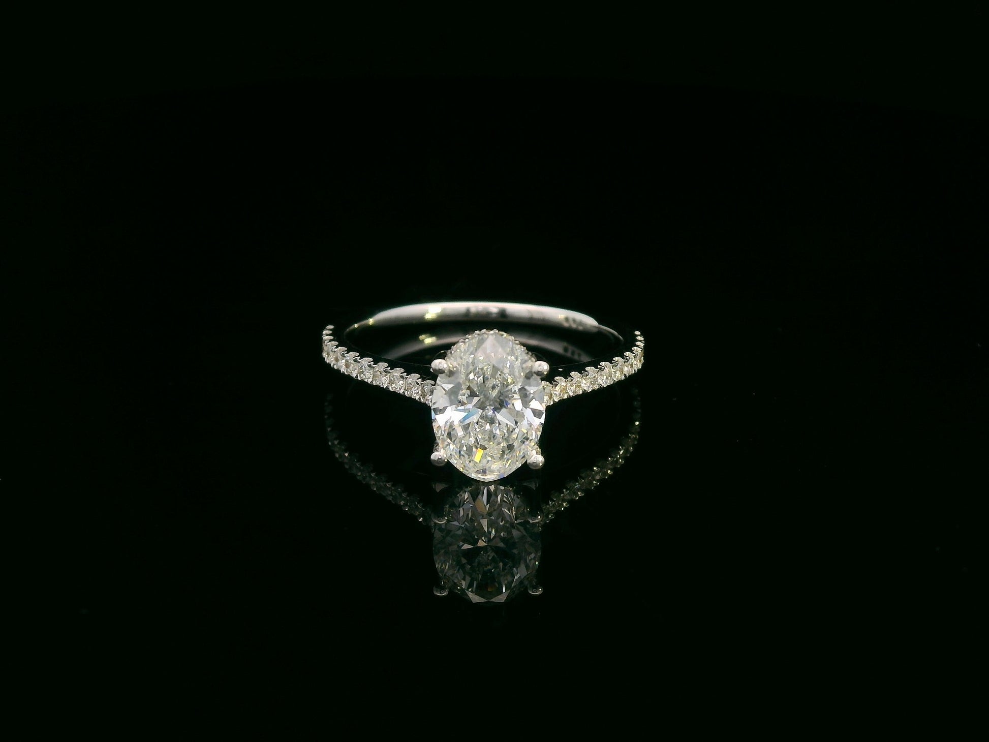 18K white gold oval diamond bridal ring set with IGI certified diamond and matching wedding band by Emirates Diamonds.