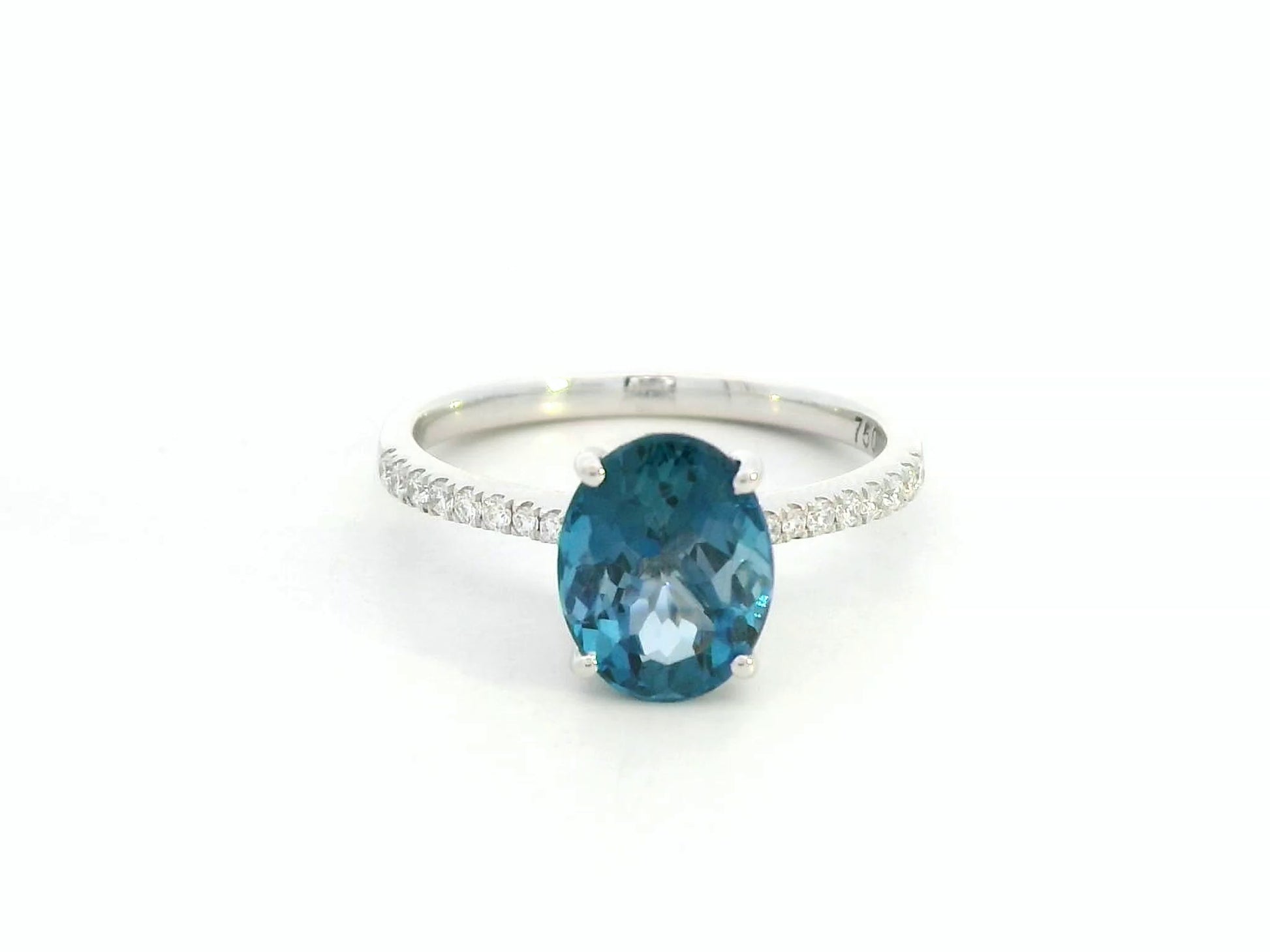 18K white gold ring featuring a 2.66 carat oval London Blue Topaz with diamond-set band, total diamond weight 0.25 carat – Emirates Diamonds