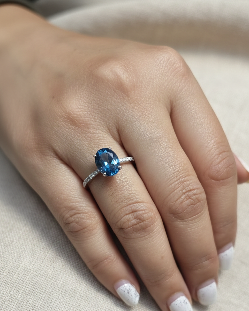 18K white gold ring featuring a 2.66 carat oval London Blue Topaz with diamond-set band, total diamond weight 0.25 carat – Emirates Diamonds