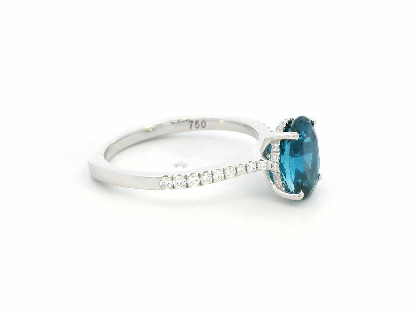 18K white gold ring featuring a 2.66 carat oval London Blue Topaz with diamond-set band, total diamond weight 0.25 carat – Emirates Diamonds