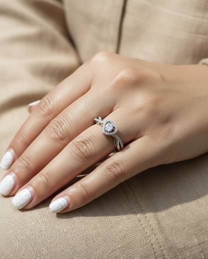 Heart-shaped diamond cluster ring in 18K white gold with pavé diamond band by Emirates Diamonds.
