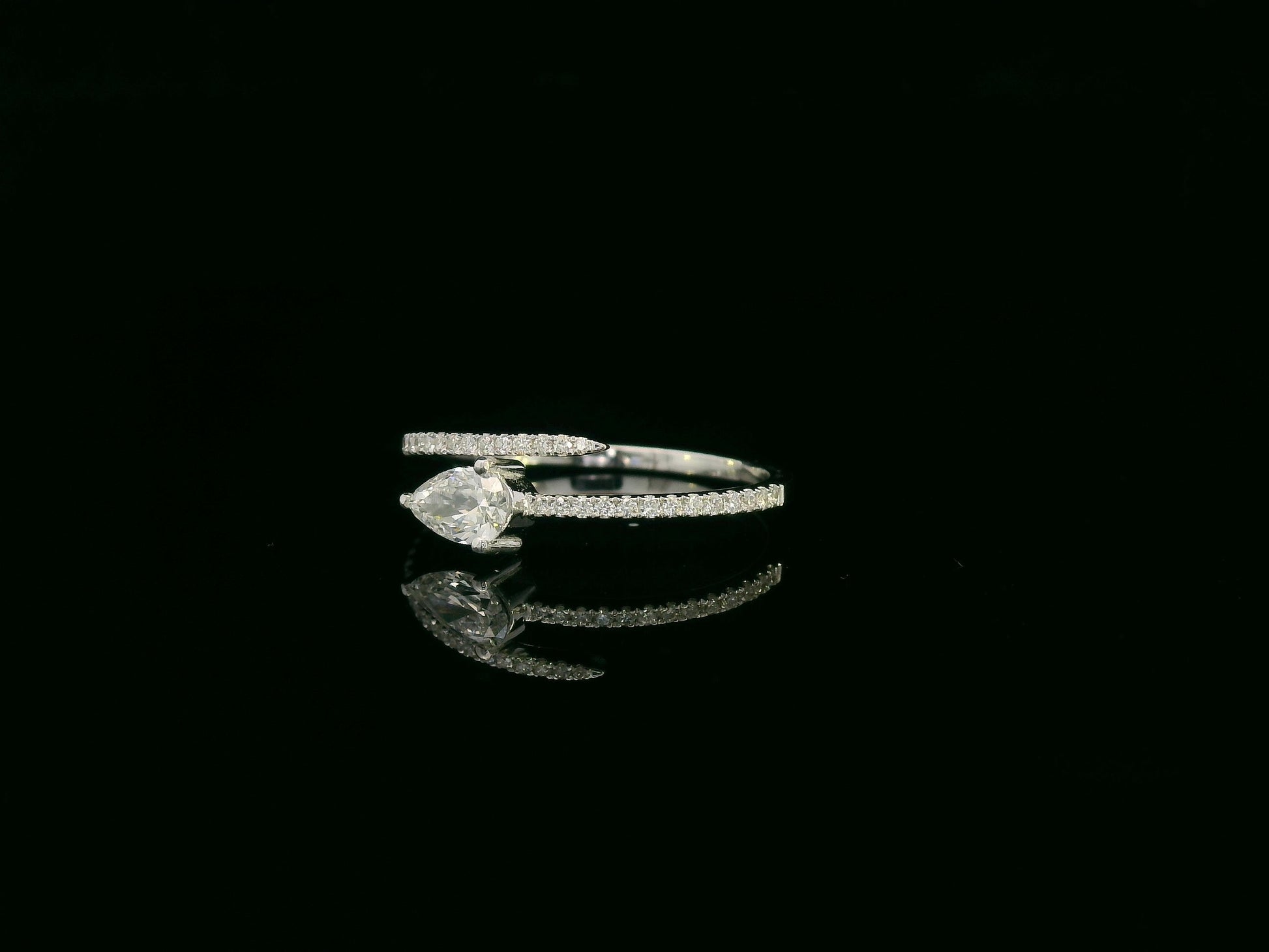 18K white gold diamond bypass ring with pear-cut diamond on one end and pavé diamond sweep, total diamond weight 0.43 carat – Emirates Diamonds