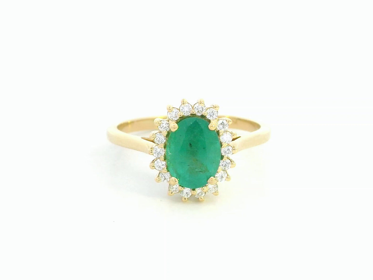 Oval emerald diamond halo ring in 18K yellow gold by Emirates Diamonds