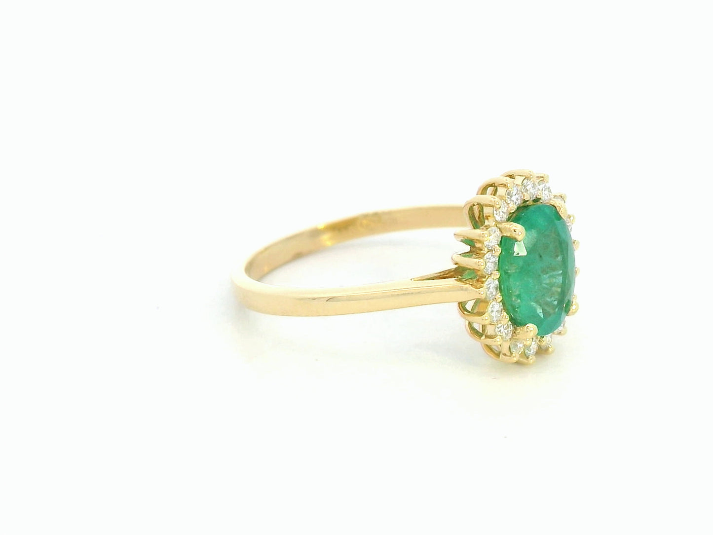 Oval emerald diamond halo ring in 18K yellow gold by Emirates Diamonds