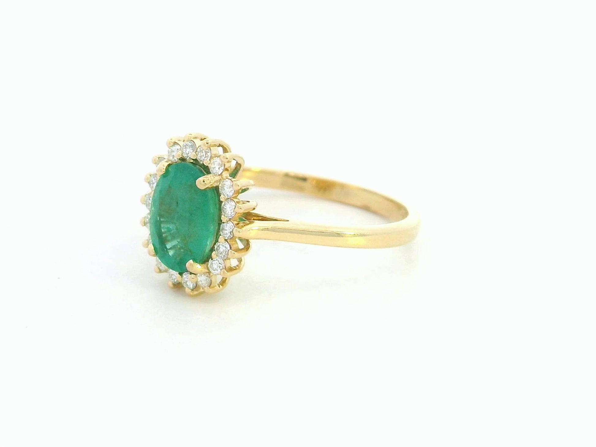 Oval emerald diamond halo ring in 18K yellow gold by Emirates Diamonds