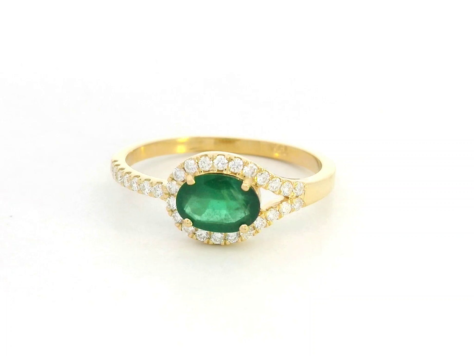 18K yellow gold ring featuring 0.59 carat oval emerald with 0.21 carat diamond accents by Emirates Diamonds.