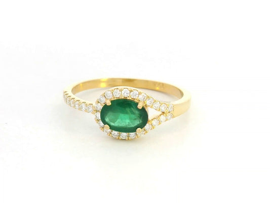 18K yellow gold ring featuring 0.59 carat oval emerald with 0.21 carat diamond accents by Emirates Diamonds.
