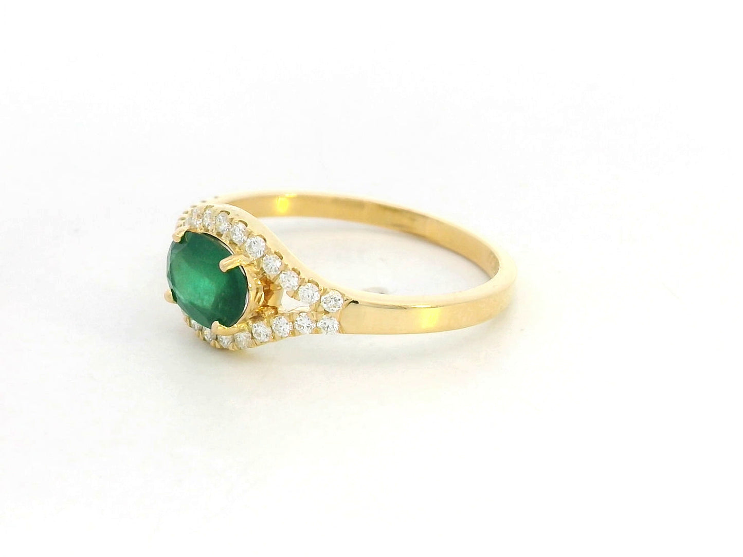 18K yellow gold ring featuring 0.59 carat oval emerald with 0.21 carat diamond accents by Emirates Diamonds.